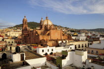 Mexico, Bajio, Zacatecas, View across flat rooftops of houses towards Cathedral.