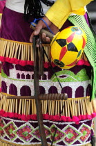 Mexico, Bajio, Zacatecas, Indigenous dance group, cropped shot of dress and musical instrument detail.