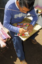 Mexico, Puebla, Cholula, Artist making reed paintings.