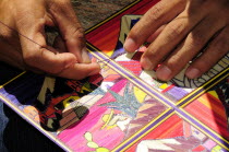 Mexico, Puebla, Cholula, Cropped view of artist making reed painting.