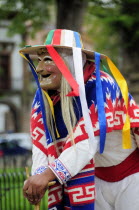 Mexico, Michoacan, Patzcuaro, Figure dressed in mask and costume for performance of Danza de los Viejitos or Dance of the Little Old Men in Plaza Vasco de Quiroga.