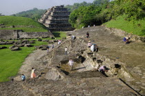 Mexico, Veracruz, Papantla, El Tajin archaeological site, Archaeologists at work at Tajin Chico with Pyramide de lo Nichos beyond.