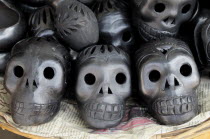 Mexico, Oaxaca, Traditional black ceramics in the form of skulls.