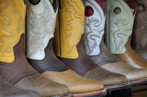 Mexico, Jalisco, Guadalajara, Line of embroidered leather boots for sale.