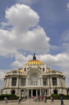 Mexico, Federal District, Mexico City, Palacio de Bellas Arte, exterior facade of Art Nouveau building with crowds of visitors in foreground.