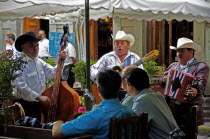 Mexico, Bajio, Guanajuato, Mariachi musicians playing at cafe in Jardin de la Union.
