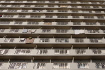 Japan, Tokyo, Exterior or an apartment block with futon mattresses hung over balcony rails to dry.