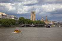 England, London, Vauxhall, Duck Tour water taxi on the river Thames heading toward the Houses of Parliament.