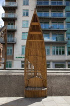 England, London, Vauxhall, Albert embankment, benches made from wood in the shape of boats.