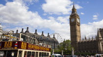 England, London, Westminster, sight seeing bus with tourists passing by the Houses of Parliament Clock Tower, better known as Big Ben.