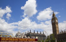 England, London, Westminster, sight seeing bus with tourists passing by the Houses of Parliament Clock Tower, better known as Big Ben.