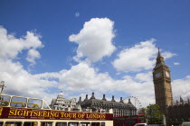 England, London, Westminster, sight seeing bus with tourists passing by the Houses of Parliament Clock Tower, better known as Big Ben.