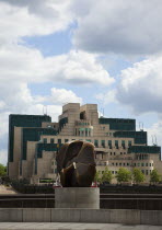 England, London, MI6 Headquarters on the Albert Embankment in Vauxhall, seen from Millbank with a Henry Moore bronze Locking Piece sculpture in the foreground.