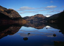 Scotland, Argyll and Bute, Loch Lubnaig, Loch Lomand and Trossachs National Park.  View north over Loch Lubnaig towards Meal Mor hill in centre at 1750 feet.  Sky and clouds reflected in water.  