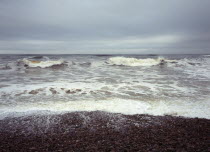 Scotland, Moray, Kingston, North facing shingle beach, looking out across rough sea and surf.