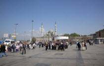 Turkey, Istanbul, Eminonu, Yeni Camii, New Mosque, main square with people walking through.