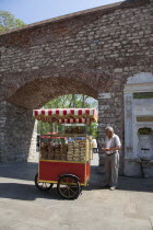 Turkey, Istanbul, Sultanahmet, bread snack vendor at the entrance to Topkapi Palace Gardens.