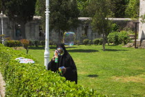 Turkey, Istanbul, Sultanahmet, woman selling bubvble gun machine in park outside the Blue Mosque.