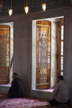 Turkey, Istanbul, Sultanahmet Camii, Blue Mosque interior with men at worship.