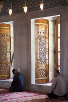 Turkey, Istanbul, Sultanahmet Camii, Blue Mosque interior with men at worship.