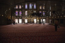 Turkey, Istanbul, Sultanahmet Camii, Blue Mosque interior with men at worship.