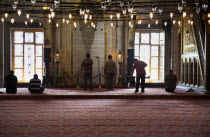 Turkey, Istanbul, Sultanahmet Camii, Blue Mosque interior with men at worship.