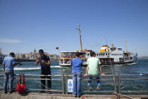 Turkey, Istanbul, Eminonu, people fishing the Bosphorus sea from the quayside.