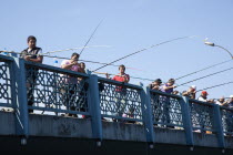 Turkey, Istanbul, Galata Bridge, people fishing.