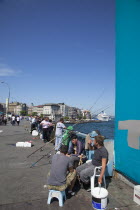 Turkey, Istanbul, Galata Bridge, people fishing.