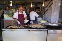 Turkey, Istanbul, Karakoy, Galata fish market, stall selling fried fish snacks.