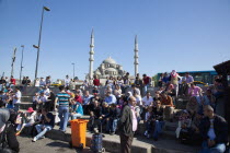 Turkey, Istanbul, Eminonu, Yeni Camii, New Mosque, people on sat on steps next to the subway.