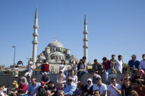 Turkey, Istanbul, Eminonu, Yeni Camii, New Mosque, people on sat on steps next to the subway.