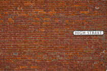 Communications, Signage, High Street sign in red brick wall.