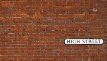Communications, Signage, High Street sign in red brick wall.