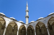 Turkey, Istanbul, Sultanahmet Camii, The Blue Mosque Courtyard and minaret with domed arches.