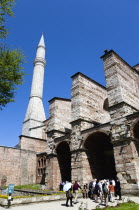 Turkey, Istanbul, Sultanahmet, Haghia Sophia Minaret with sightseeing tourists entering the Outer Narthex leading to the Imperial Gate entrance.