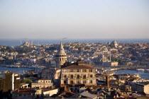 Turkey, Istanbul, View from Beyoglu across rooftops to Galata Tower and Golden Horn with Galata Bridge leadingto Sultanahmet with Haghia Sophia, New Mosque and Blue Mosque with Sea of Marmara beyond.