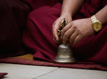 India, Sikkim, Buddhist Monk playing musical bell in a Losar ceremony.