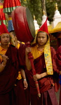 India, Sikkim, Buddhist Monk playing a drum in a Losar ceremonial procession.