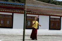India, Sikkim, Buddhist monk playing badminton.