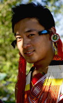 India, Nagaland, Naga Warrior in traditional costume and jewelry.