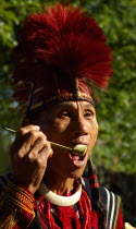 India, Nagaland, Naga Warrior in traditional costume and head dress.