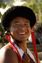 India, Nagaland, Naga Warrior tribal in traditional costume and head dress.