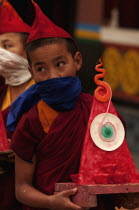 India, Sikkim, Buddhist monk carrying a wax art offering for the Losar ceremony.