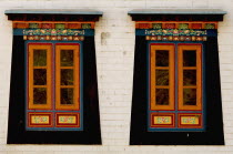 India, Sikkim, hand crafted and painted windows in a Buddhist monastery.