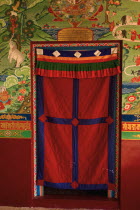 India, Suikkim, hand crafted and entrance doorway in a Buddhist monastery.