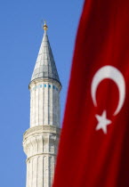Turkey, Istanbul, Sultanahmet, Haghia Sophia minaret and Turkish red flag with white crescent moon and star.