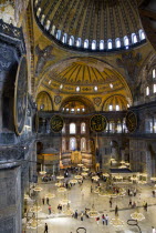Turkey, Istanbul, Sultanahmet, Haghia Sophia The nave with tourists sightseeing below the dome and suspended lights.