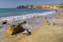 Ireland, County Waterford, Tramore, Kilfarrasy Beach and coastline with people riding horseback.