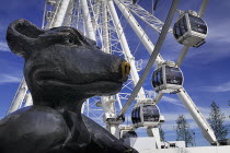 Ireland, County Dublin, Dublin City, North Quay, Point Village, Ferris Wheel tourist attraction with animal sculpture in the foreground.